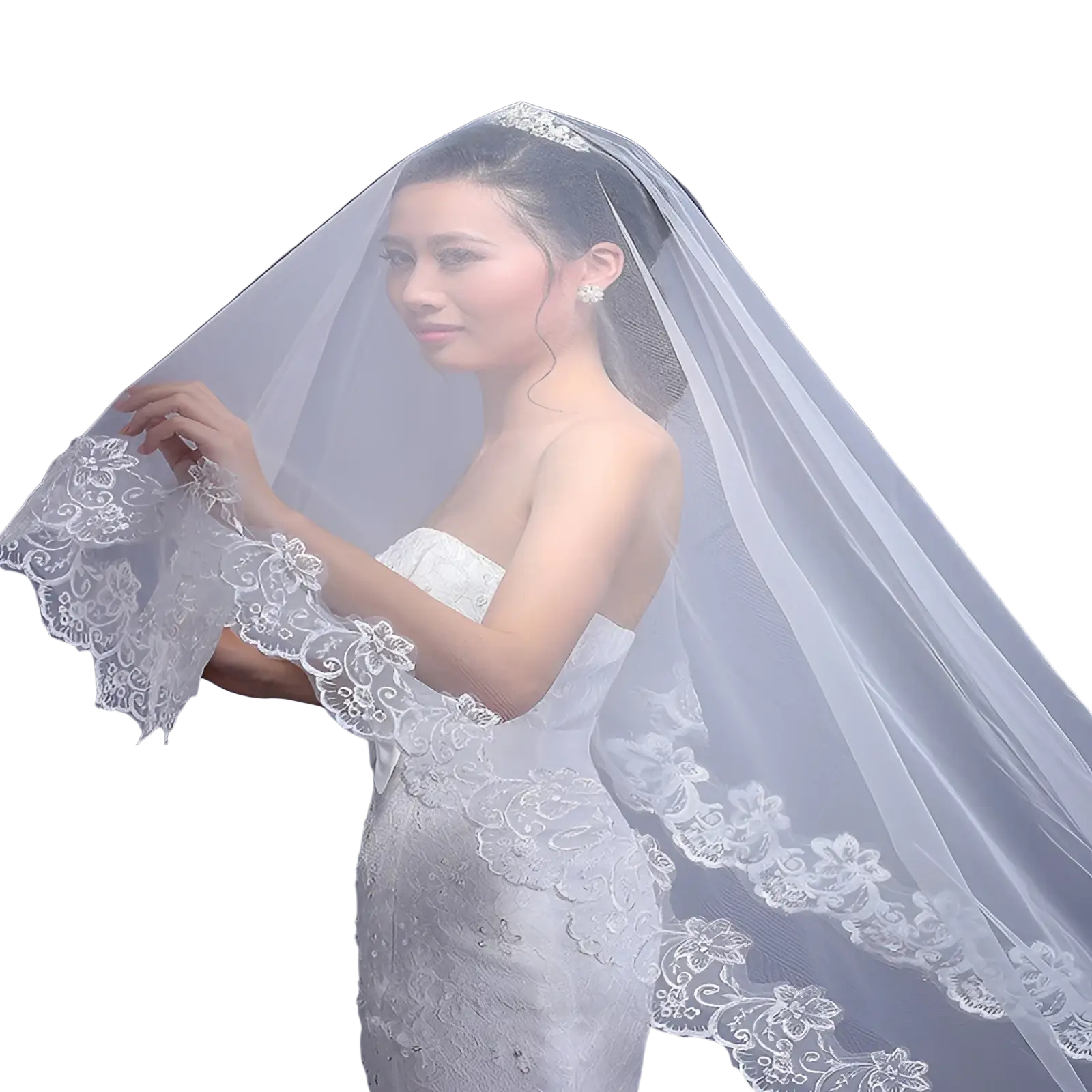 Delicate white lace embroidered floral cathedral wedding veil with intricate edges draped over the bride’s shoulders