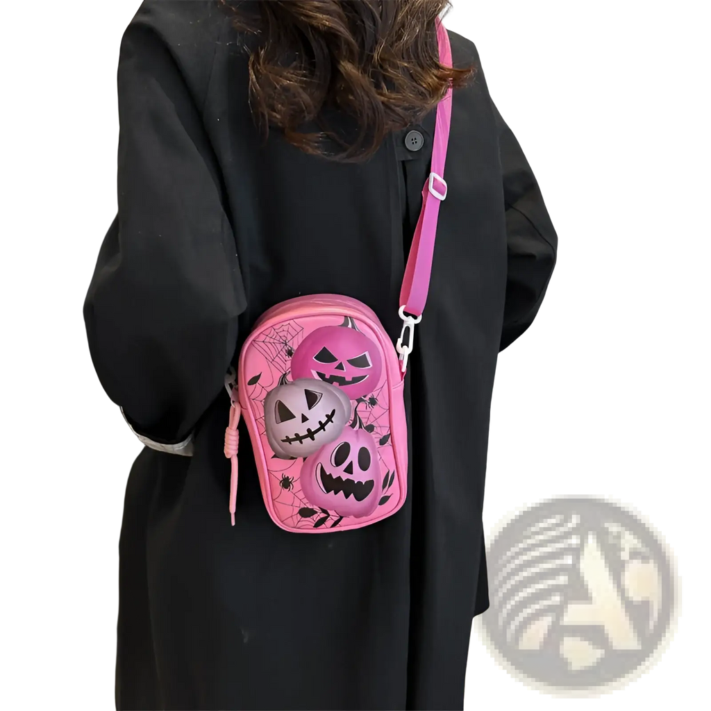 Pink embroidered halloween floral and pumpkin crossbody bag with jack-o-lanterns and spiderweb designs