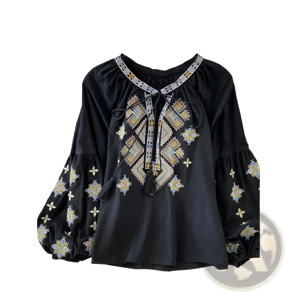 Black embroidered lantern sleeve blouse with intricate gold silver and white geometric patterns and tie-front tassels
