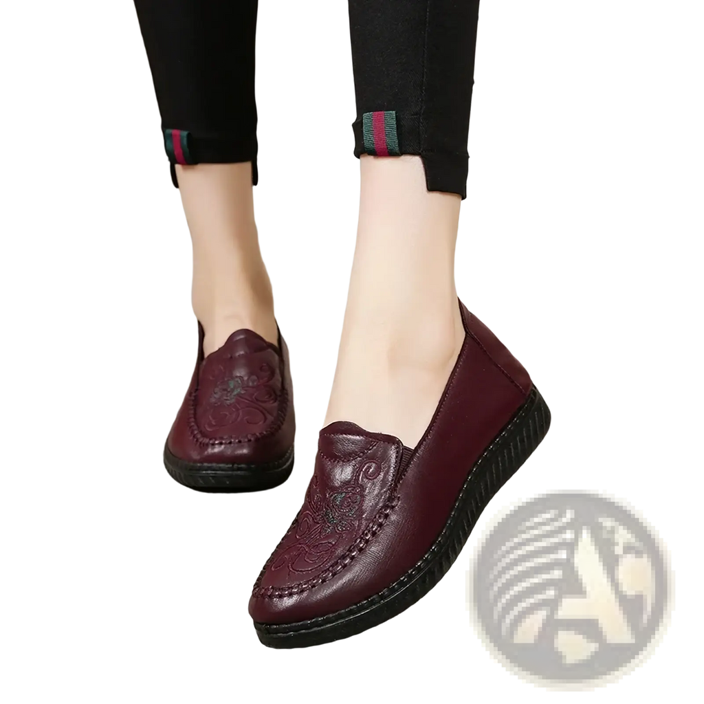 Burgundy leather slip on loafers with embroidered floral patterns and black rubber sole