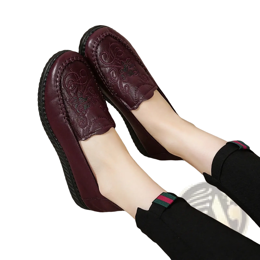 Embroidered leather slip on loafers in deep burgundy featuring intricate floral embroidery and a textured rubber sole