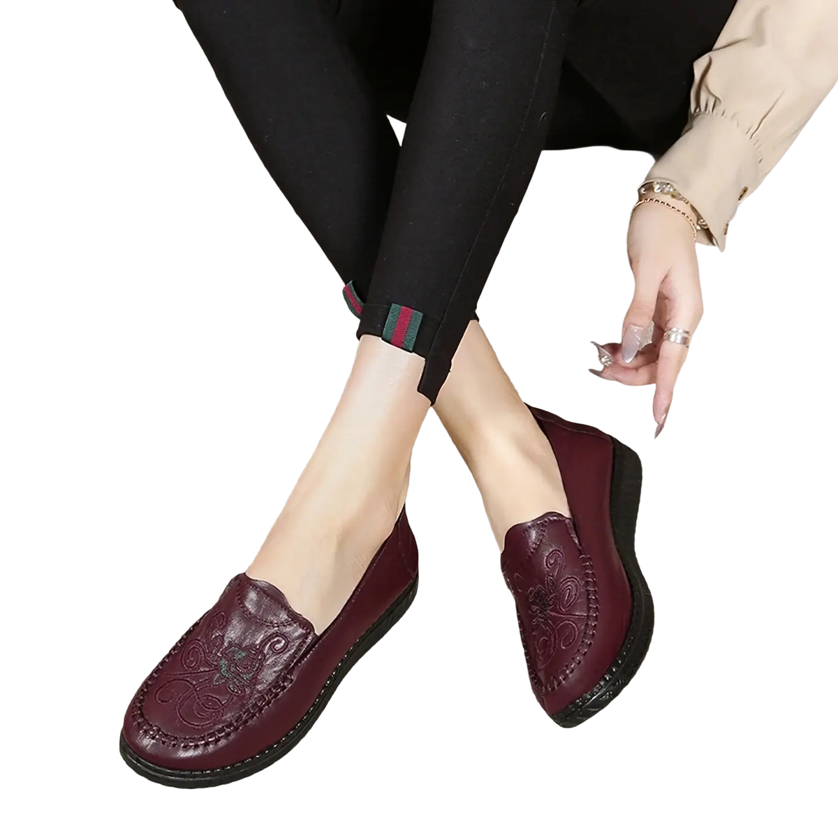 Maroon leather slip on loafers with embossed floral patterns and a black rubber sole for elegant wear