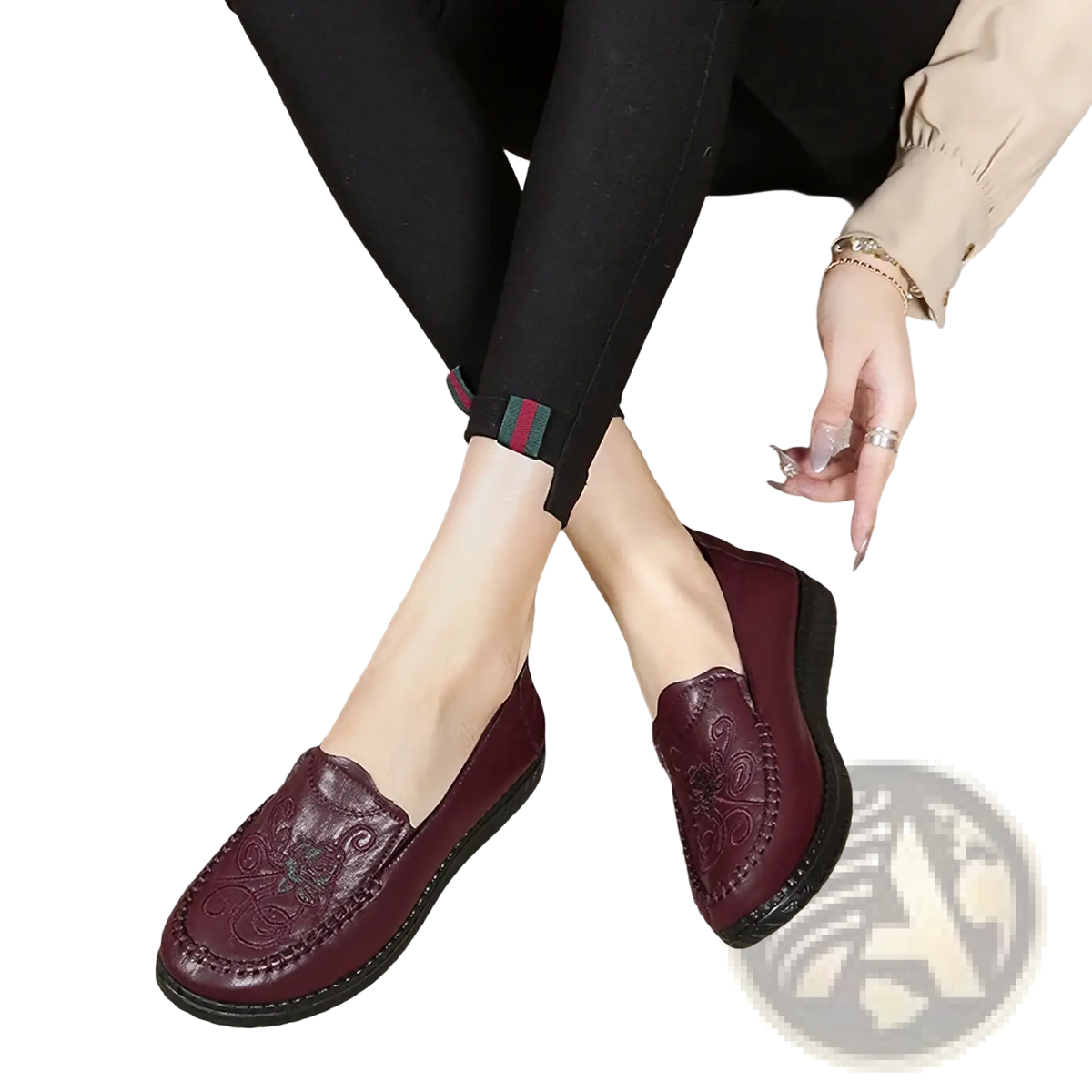 Maroon leather slip on loafers with embossed floral patterns and a black rubber sole for elegant wear