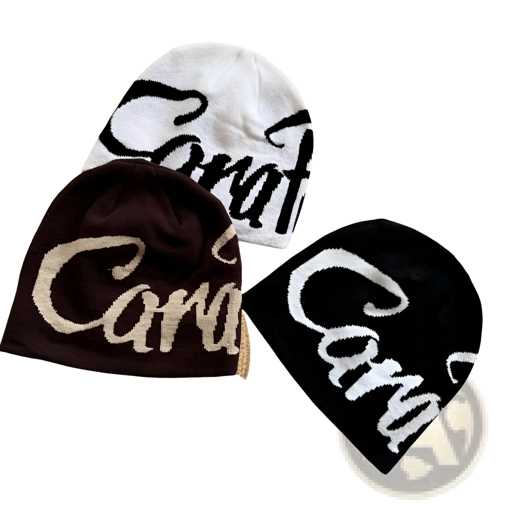 Three knitted embroidered letter knit beanie hats in white, dark brown, and black featuring cara logo designs