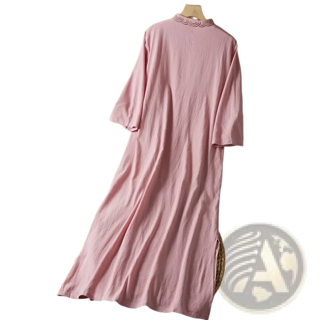 A soft pink embroidered linen dress with long sleeves scalloped neckline and side slit ideal for summer outfits