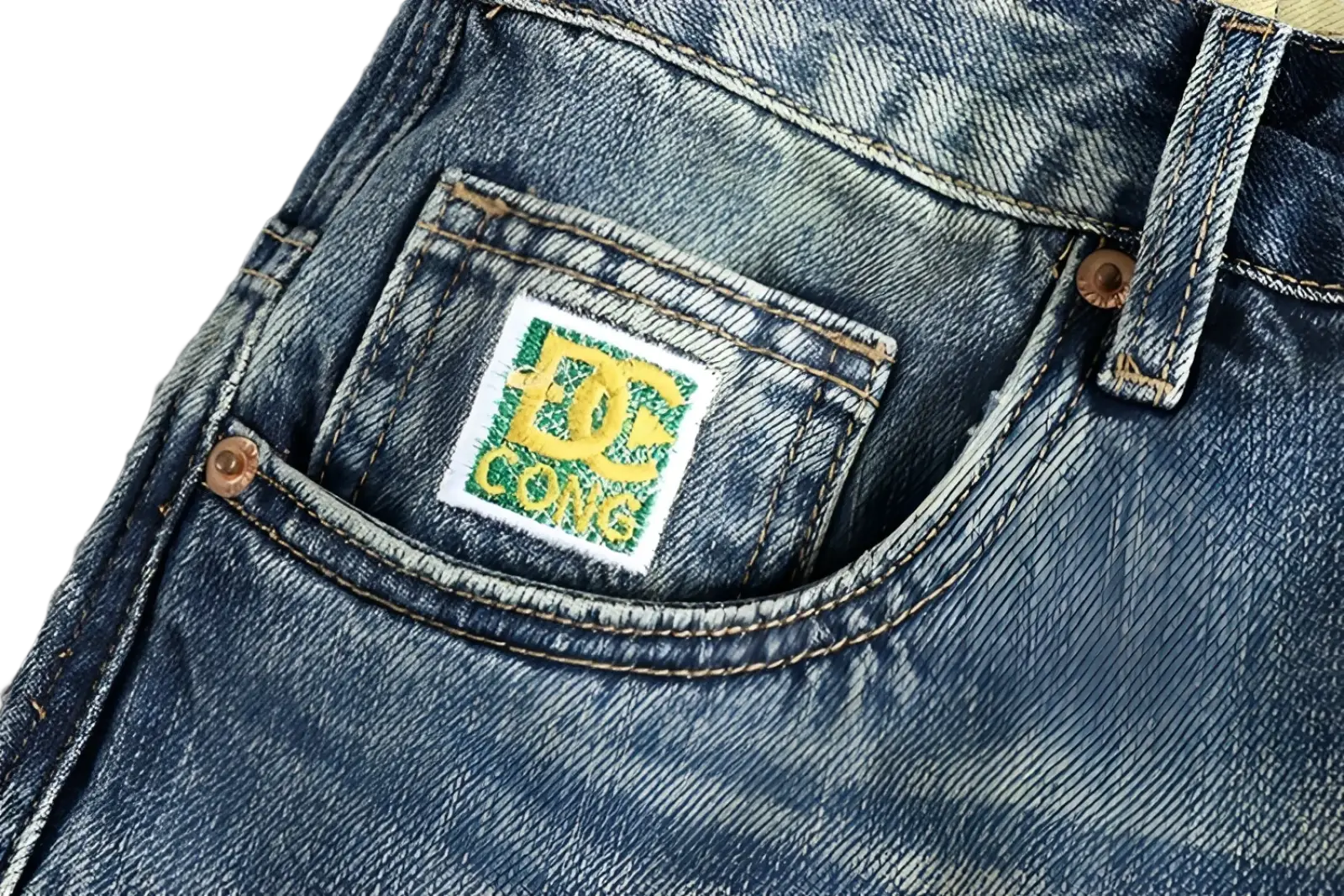 Blue denim loose fit jeans for men with a white embroidered patch featuring a green dc logo and text on the back side