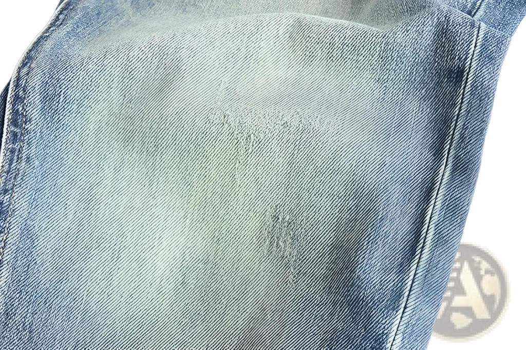 Embroidered loose fit light-wash denim jeans for men with subtle fading and distressed patches in cotton material