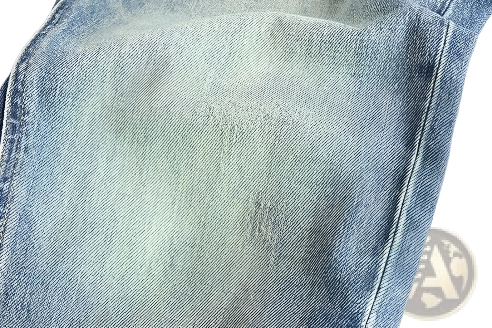 Embroidered loose fit light-wash denim jeans for men with subtle fading and distressed patches in cotton material