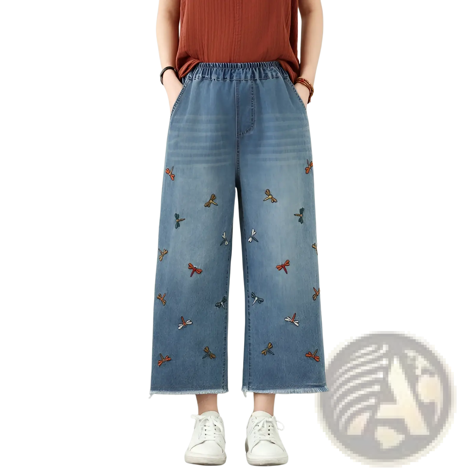 Light blue denim wide-leg jeans featuring colorful embroidered dragonflies in red orange and teal