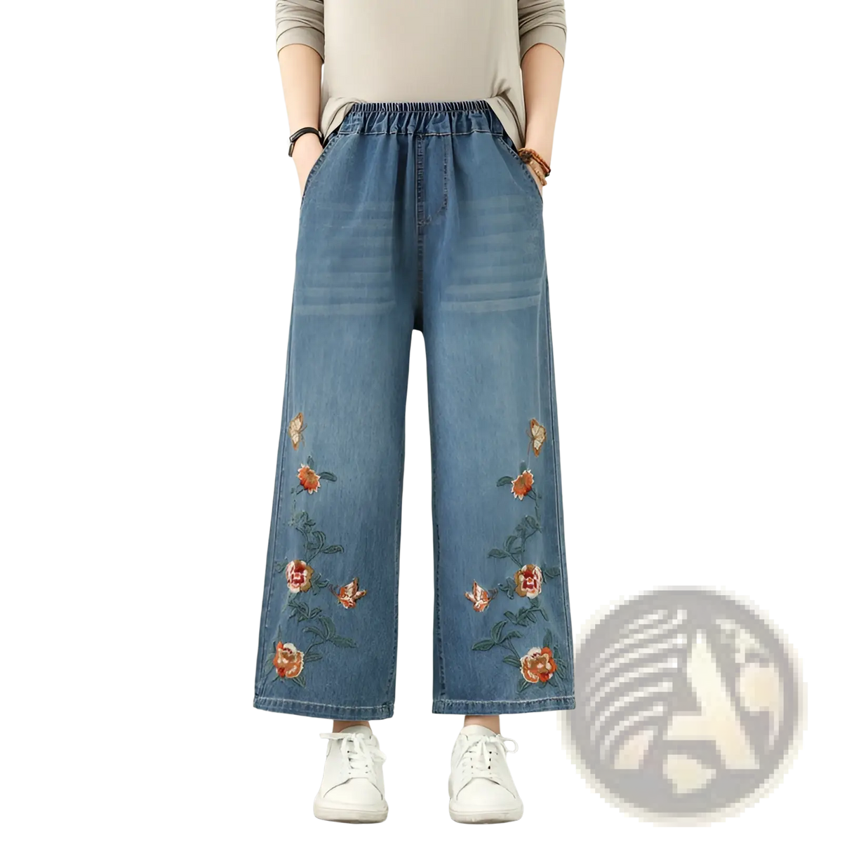 Blue denim wide leg jeans with embroidered orange and green floral patterns on the lower legs