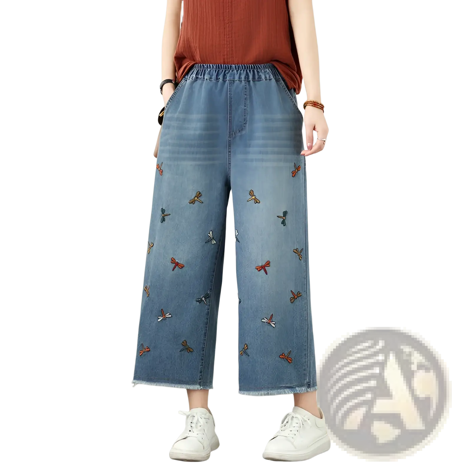 Blue denim wide leg jeans featuring colorful embroidered red orange and blue dragonflies on the front side