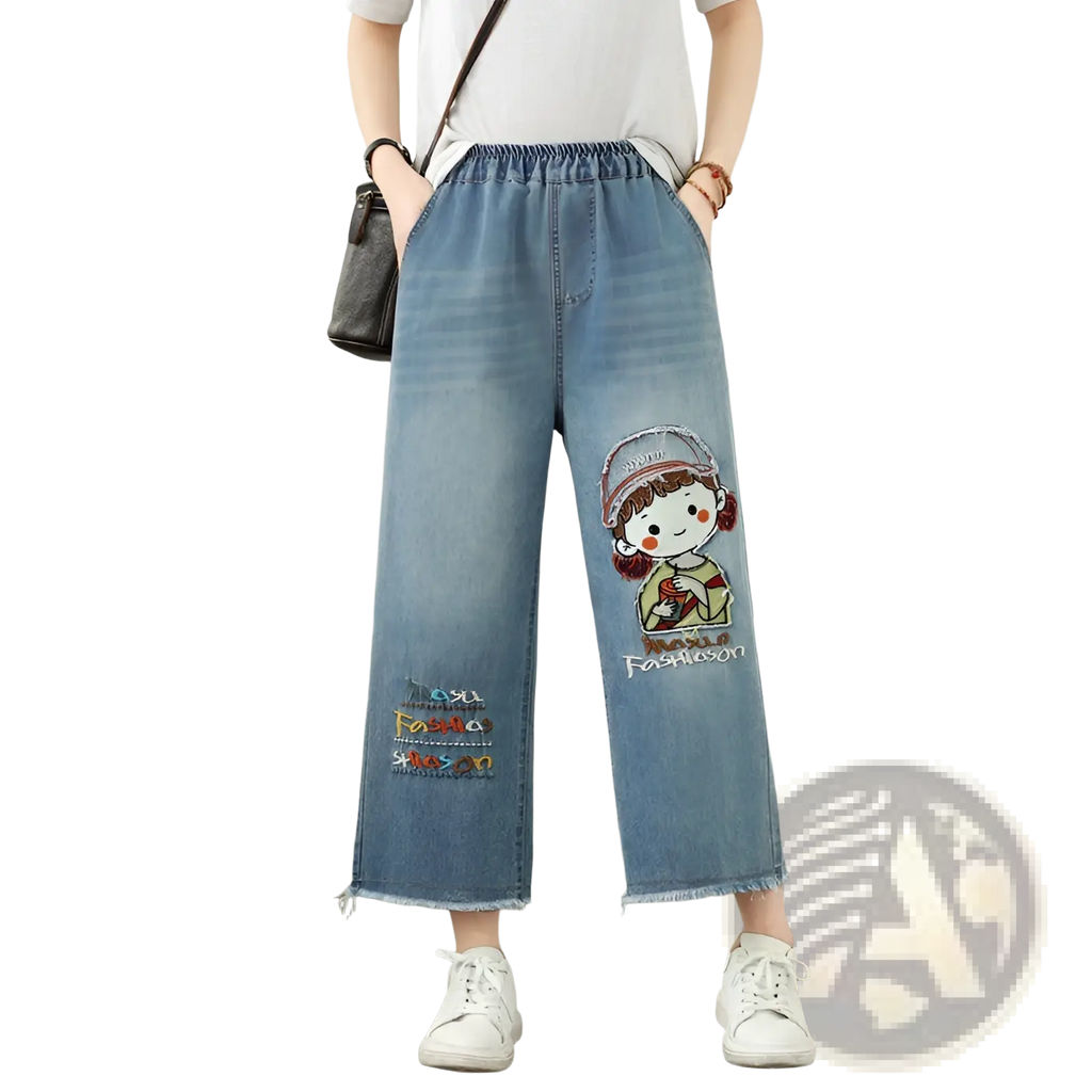 Light blue denim embroidered wide leg jeans featuring a cartoon girl and the word fashion below the embroidery
