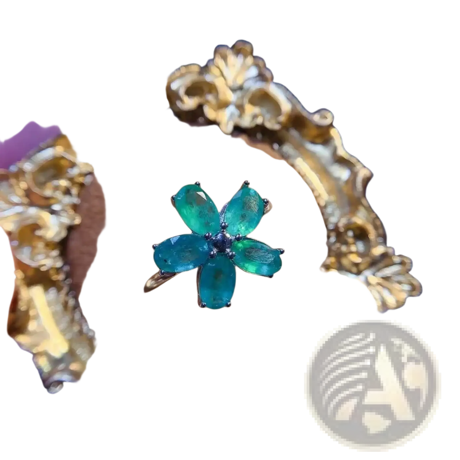 Emerald flower silver ring with five oval-cut green stones and dark blue center set in ornate gold band