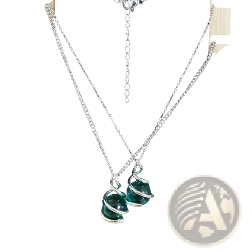 Silver chain necklace with two emerald green glass beads wrapped in a spiral silver wire design pendant
