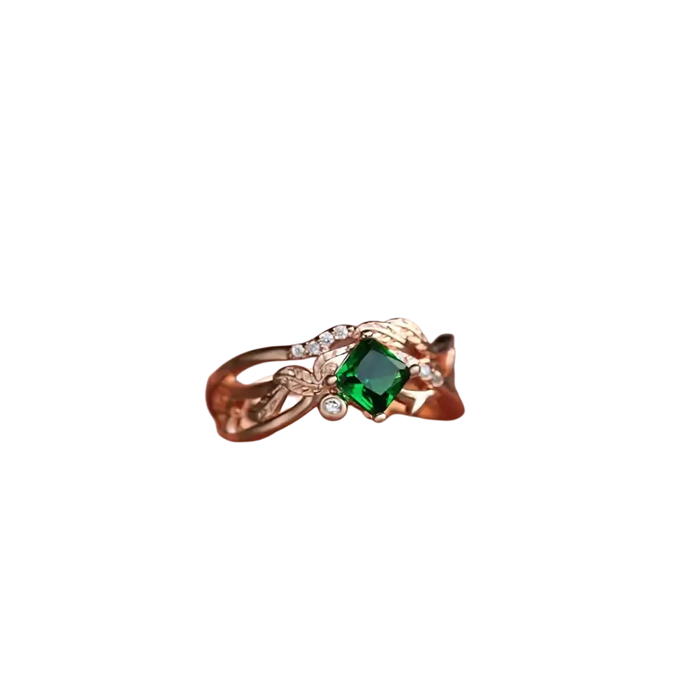 Emerald rose gold ring with square-cut emerald center stone and diamond leaf accents in elegant design