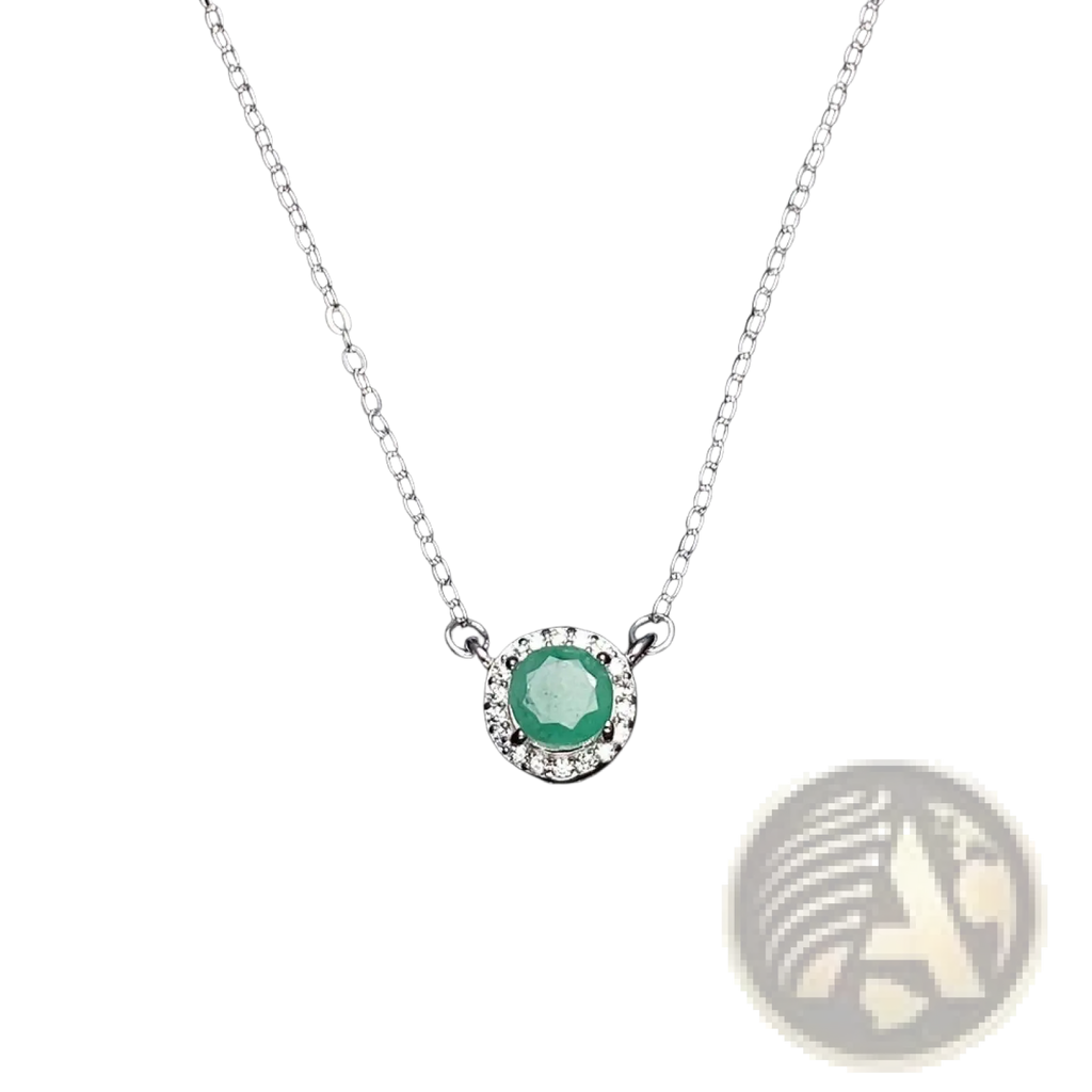 A delicate emerald sterling silver necklace with a central round emerald surrounded by a diamond halo