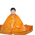 Bright orange emergency thermal blanket with shiny reflective surface for survival and heat retention