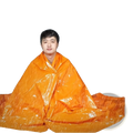 Bright orange emergency thermal blanket with shiny reflective surface for survival and heat retention