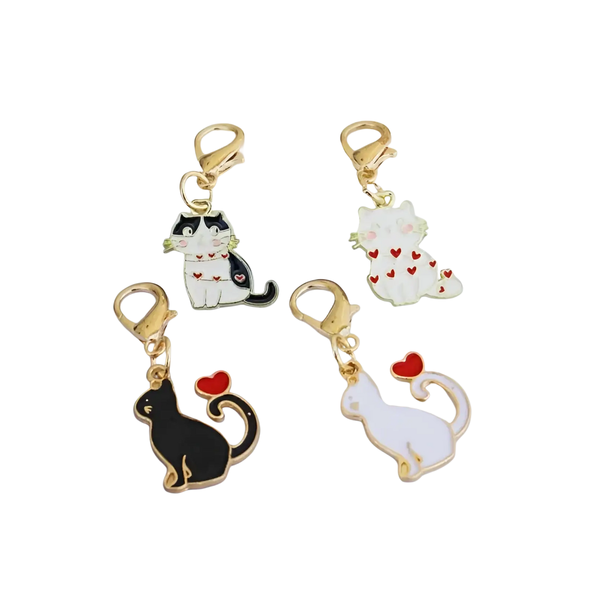 Set of four enamel cat keychain charms with gold-tone clasps featuring black-and-white and white cats with red hearts