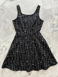 Black sleeveless skater dress with white mathematical equations print and pockets for casual wear