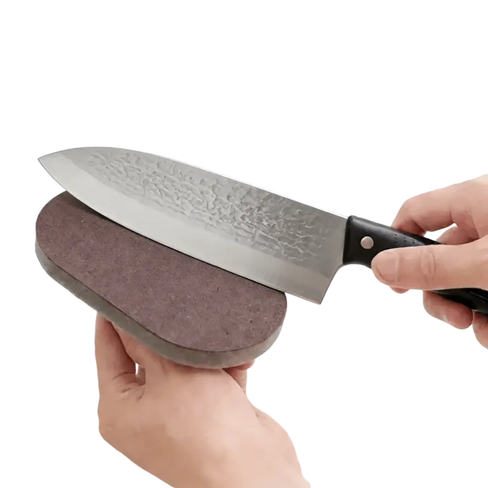 Ergonomic kitchen scrubber sponge with handle showing dark brown oval dual-sided textured knife sharpening stone back side