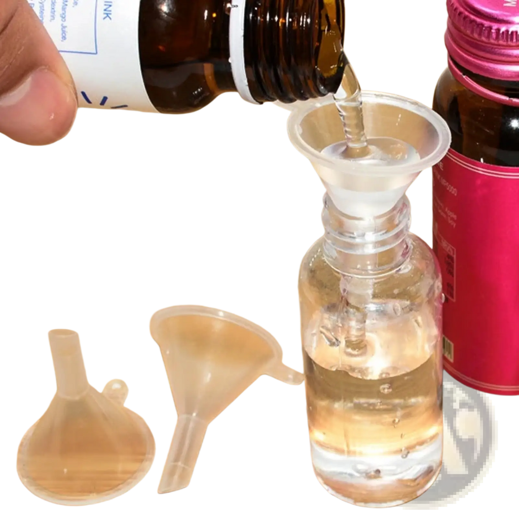 Clear plastic funnel from essential oil dispenser tool set 3pcs pouring liquid from brown bottle into transparent glass bottle