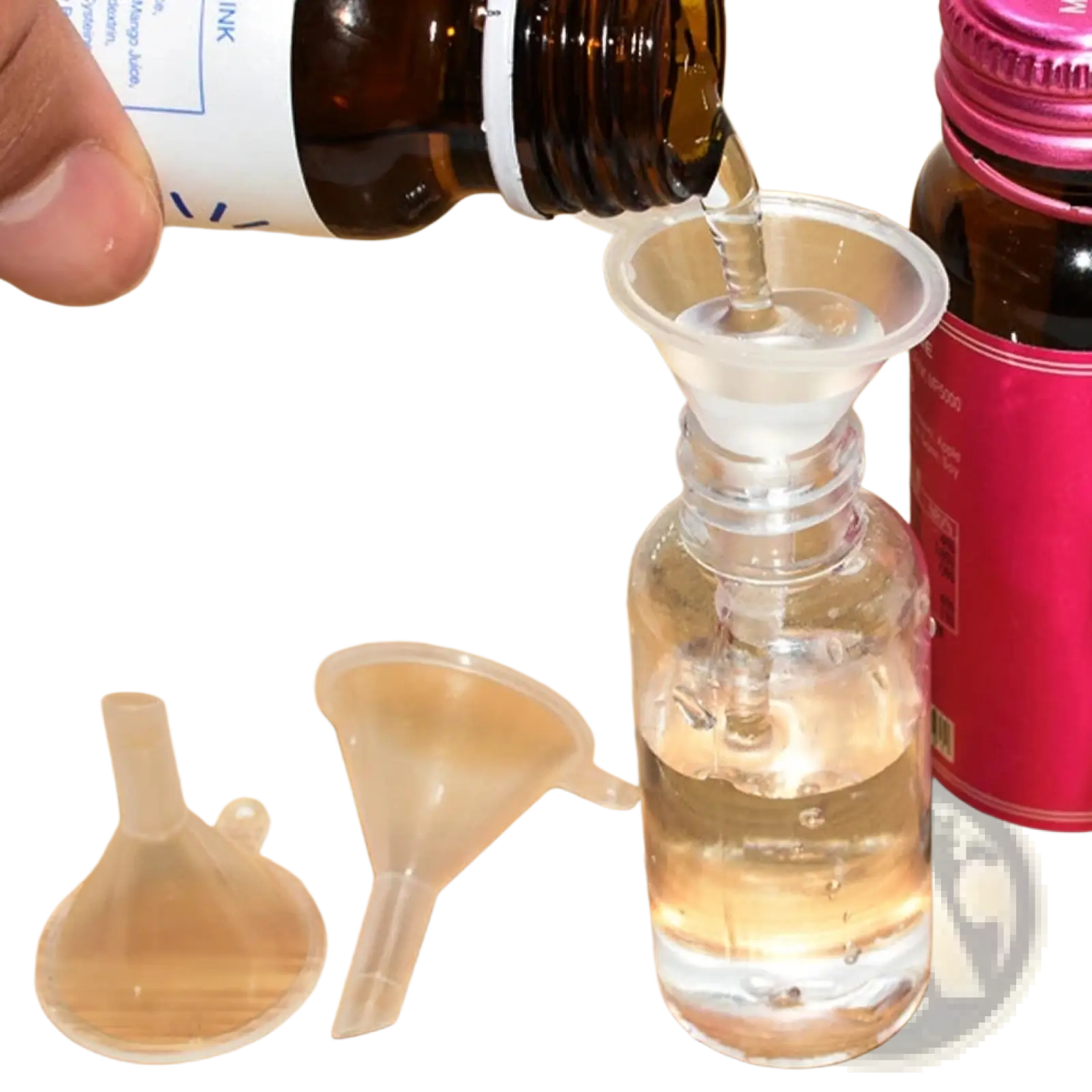 Clear plastic funnel from essential oil dispenser tool set 3pcs pouring liquid from brown bottle into transparent glass bottle