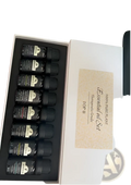 Black glass essential oil bottles with black caps in a white gift box labeled essential oil set for pure plant aromatherapy