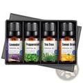 Set of four amber glass essential oil bottles with black ribbed caps in a sleek black gift box for aromatherapy