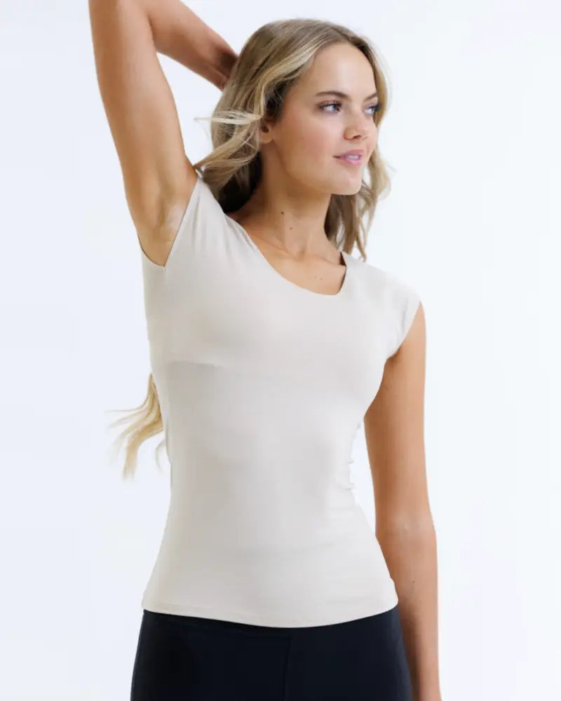 A sleek off-white essential tri-blend sleeveless top with a soft form-fitting fabric and subtle scoop neckline