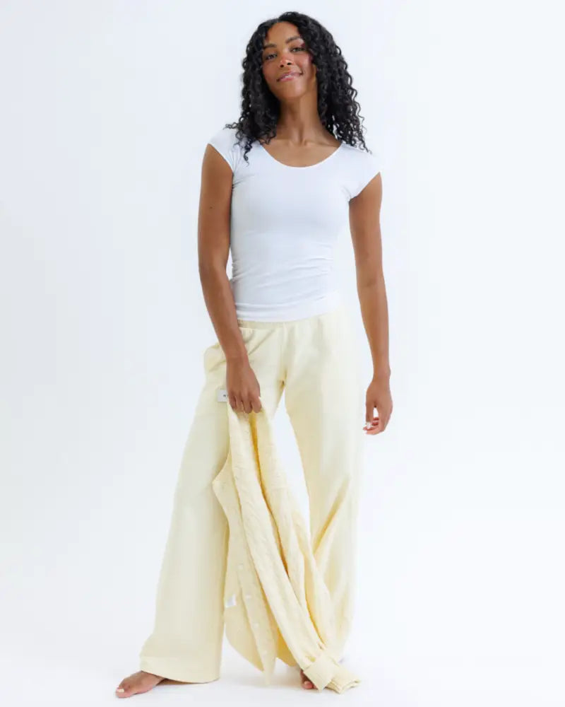 Cream-colored flowing wide-leg pants with relaxed fit paired with essential tri-blend scoop neck fitted tee