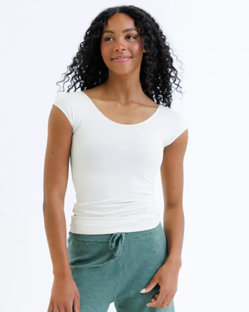 White essential tri-blend fitted tee with scoop neck short sleeves and subtle waist ruching for casual wear