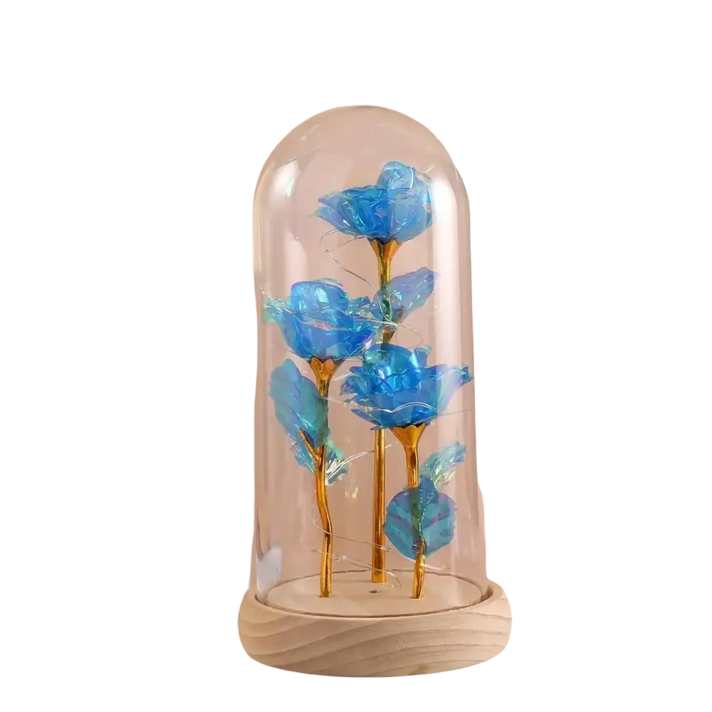Eternal gold rose glass dome led light featuring three vibrant blue roses with golden stems on a light wood base