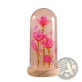 A vibrant pink glittery eternal gold rose with golden stems inside a glass dome on a wooden base with led light