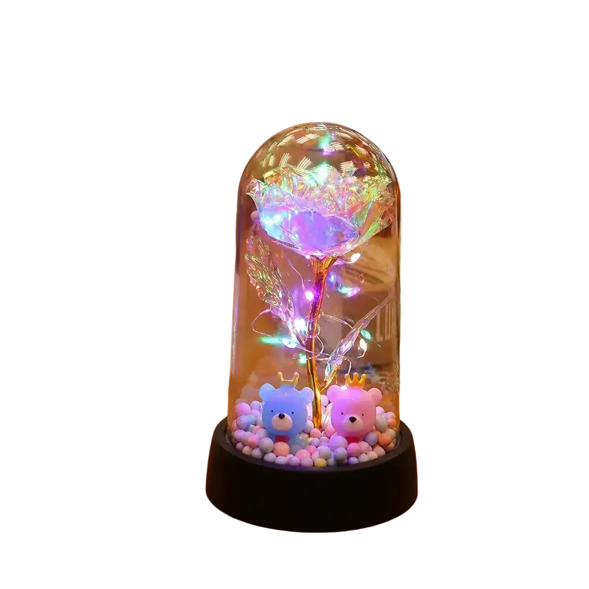 A glowing iridescent gold rose encased in a clear glass dome with led light and two small plush bears at its base