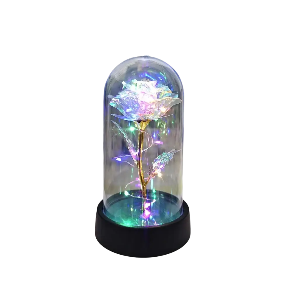 A glowing iridescent rose with a golden stem inside a glass dome on a black base eternal gold rose led light gift