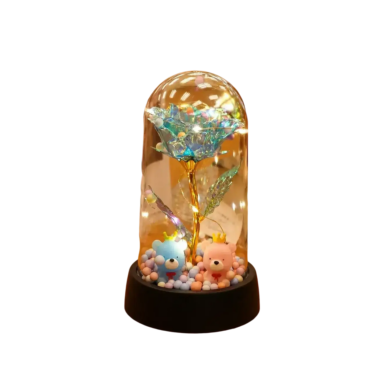 A glowing gold rose with a golden stem inside a glass dome led light display surrounded by colorful beads and bears