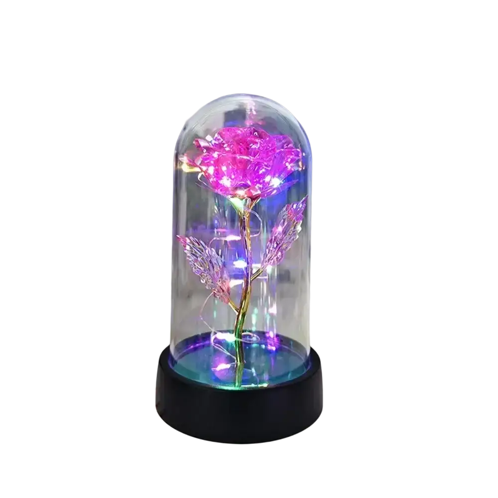 Eternal gold rose led light in a glowing pink glass dome with a black base for decorative gifting