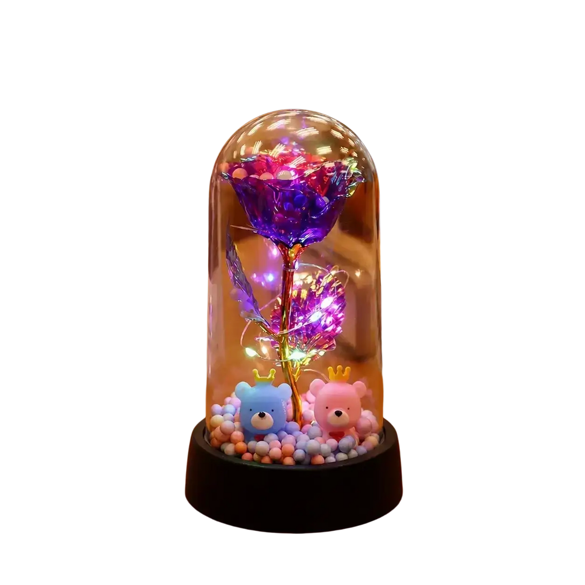 A glowing purple gold rose with led light encased in a clear glass dome surrounded by beads and plush bears