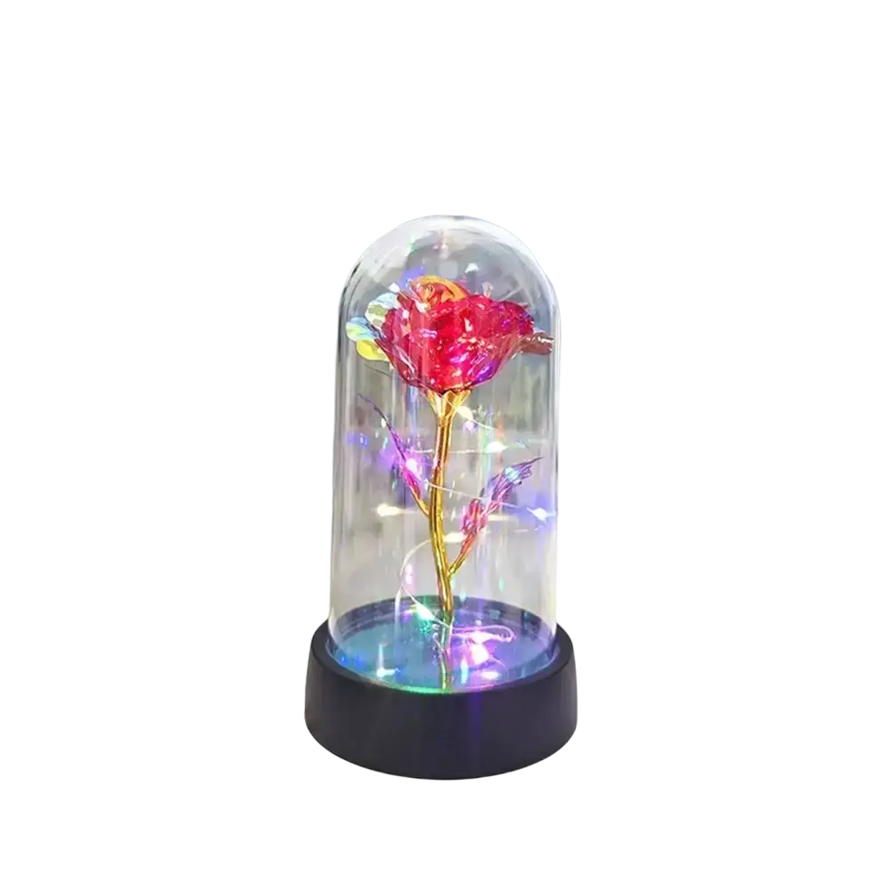 A glowing red gold rose encased in a glass dome illuminated by colorful led light for an elegant gift