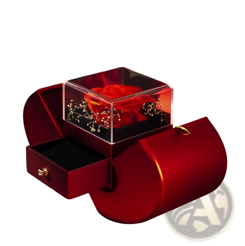 A vibrant red preserved rose inside a clear acrylic cube atop a burgundy velvet eternal rose apple jewelry box