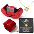 Red metallic heart-shaped eternal rose apple jewelry box with clear acrylic lid holding a preserved rose and hidden drawer