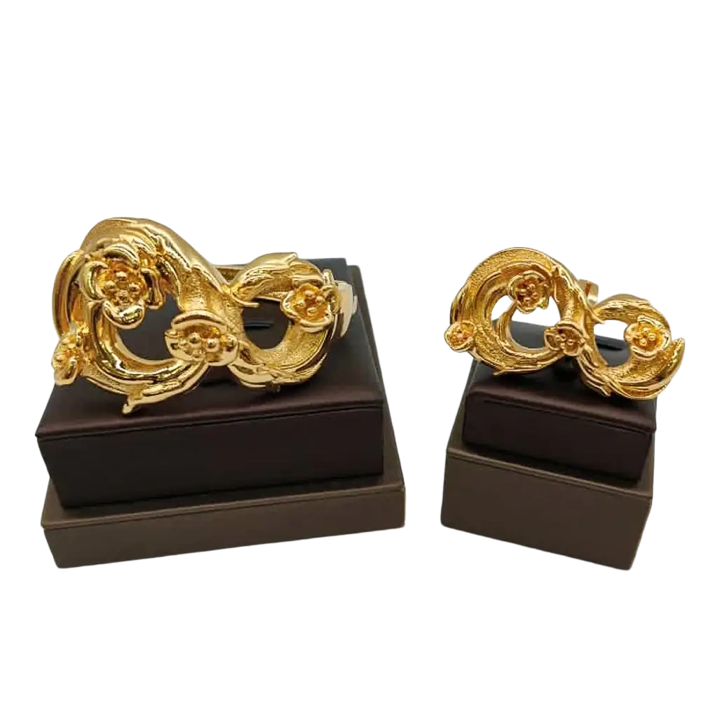 Gold-colored ornate cufflinks with intricate floral and swirling designs for ethiopian arabic hand luxury jewelry