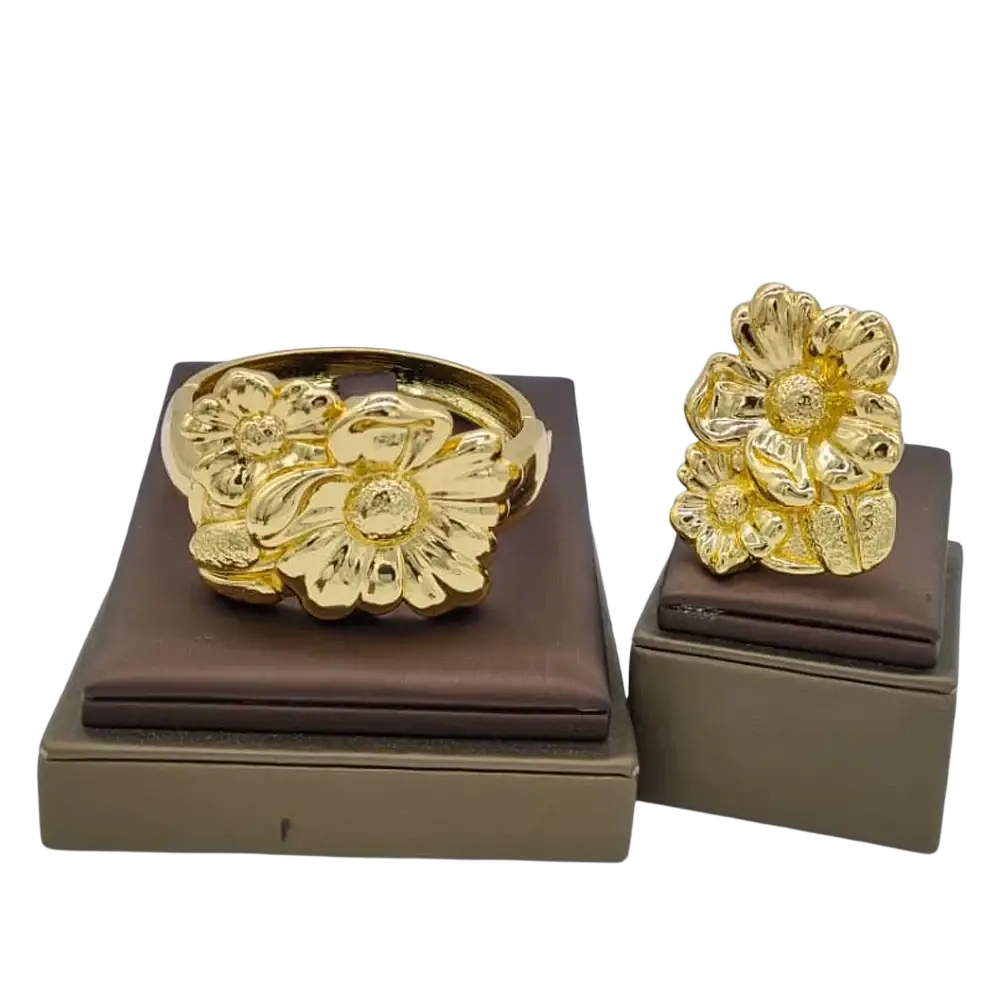Gold floral bracelet and matching ring set with detailed petals and textured center in ethiopian arabic hand luxury jewelry color bangles