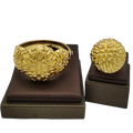 Golden intricately textured ethiopian arabic color bangles hand luxury jewelry displayed on brown velvet stands