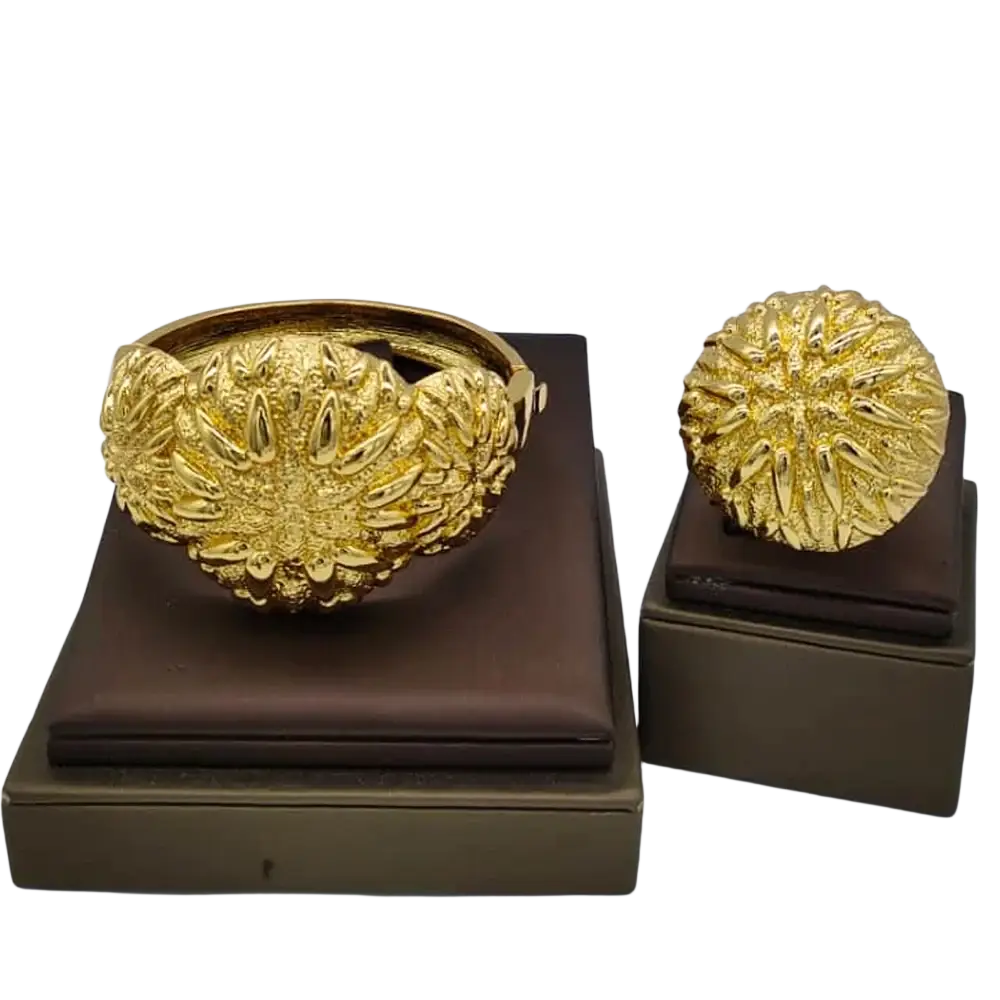 Golden intricately textured ethiopian arabic color bangles hand luxury jewelry displayed on brown velvet stands