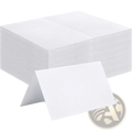 Stack of white folded eucalyptus leaf place cards made of paper for wedding table seating arrangements