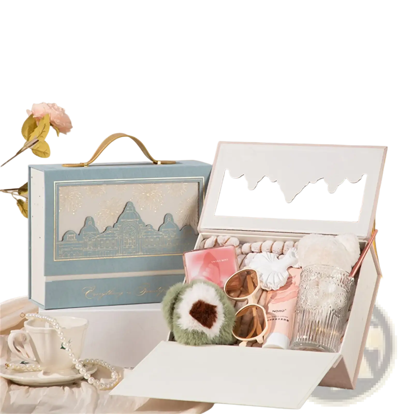 Light blue European style wedding gift box with gold handle and cityscape design open showing pink white beauty products