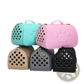 Eva folding pet carrier bag in pink with paw prints features circular ventilation holes and a top handle for easy carrying