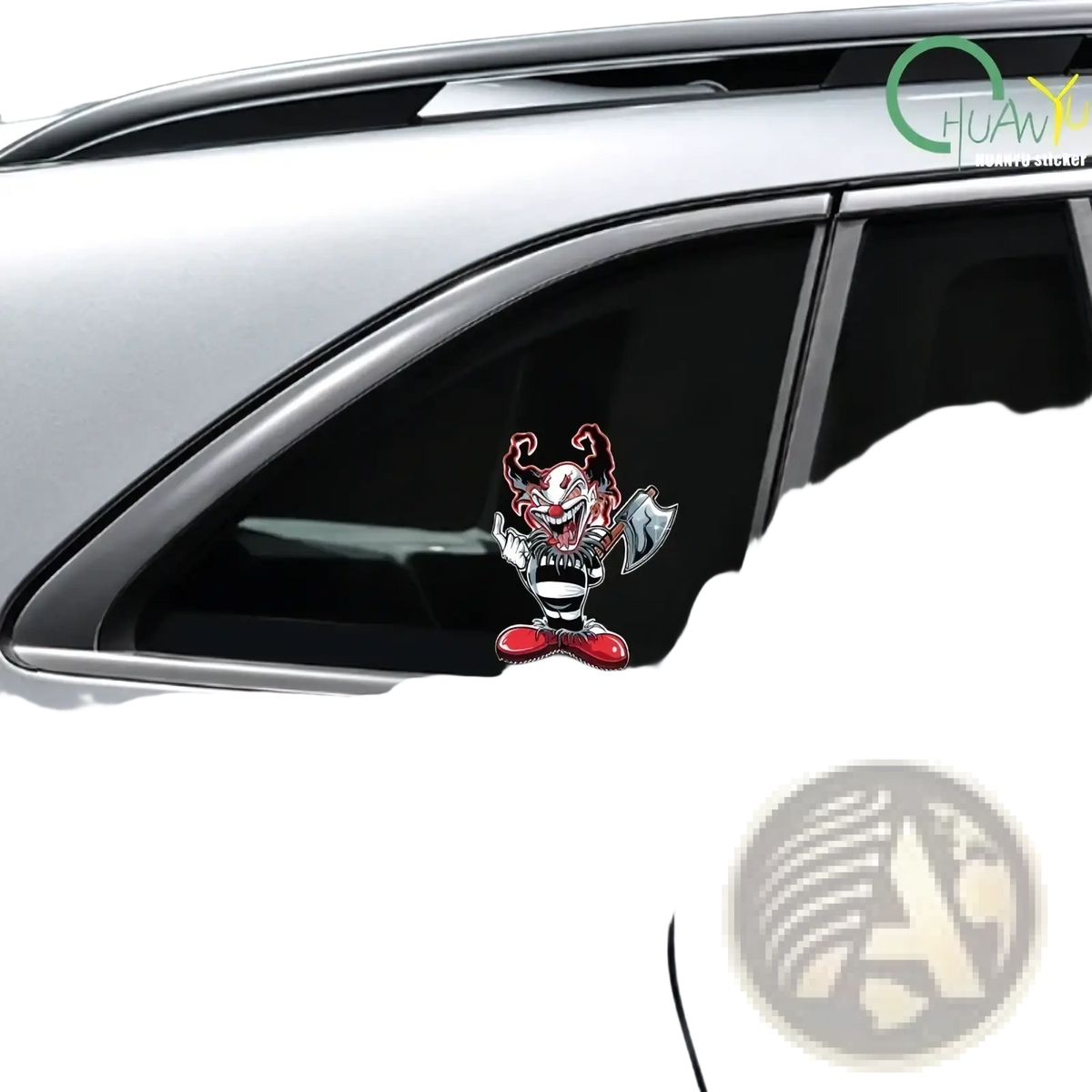 A vibrant red and black evil clown car sticker with a menacing grin and axe on the rear window of a silver car